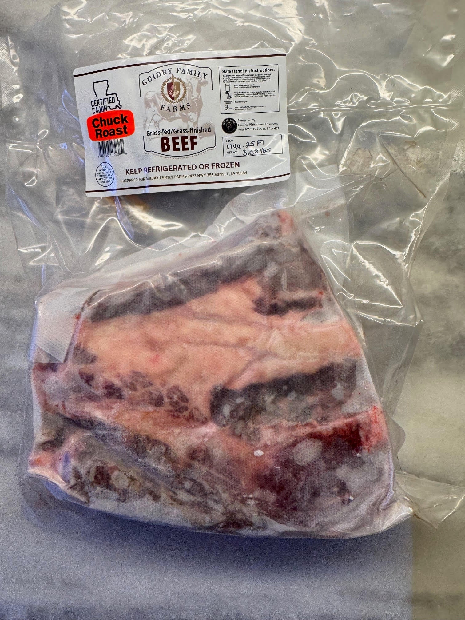 Packaged beef with a label on a marble surface